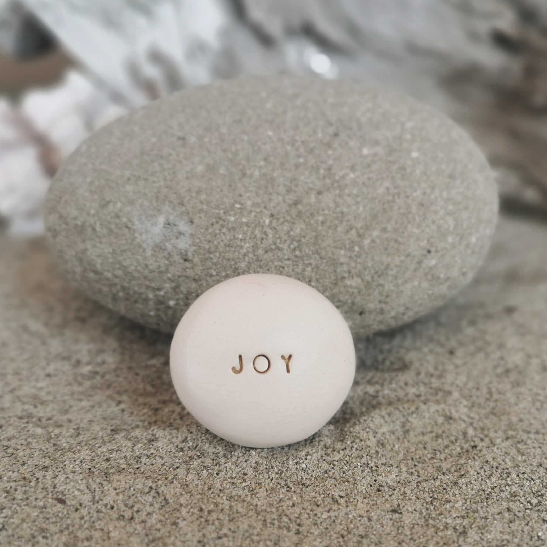 JOY - Motivational message ceramic pebble