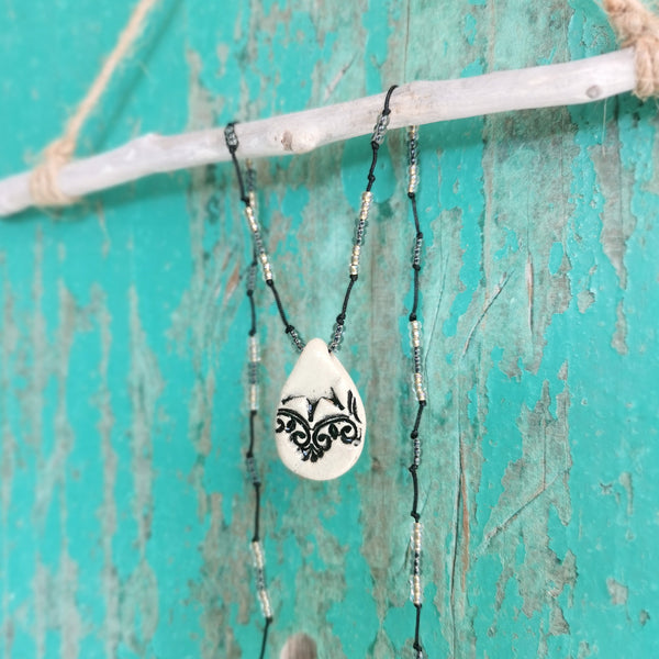 Collana in ceramica con motivo pressato in stile vintage infilata su perle