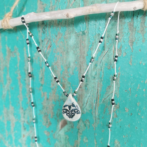 Collana in ceramica con motivo pressato in stile vintage infilata su perle