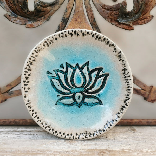 Turquoise ceramic bowl with lotus flower pattern