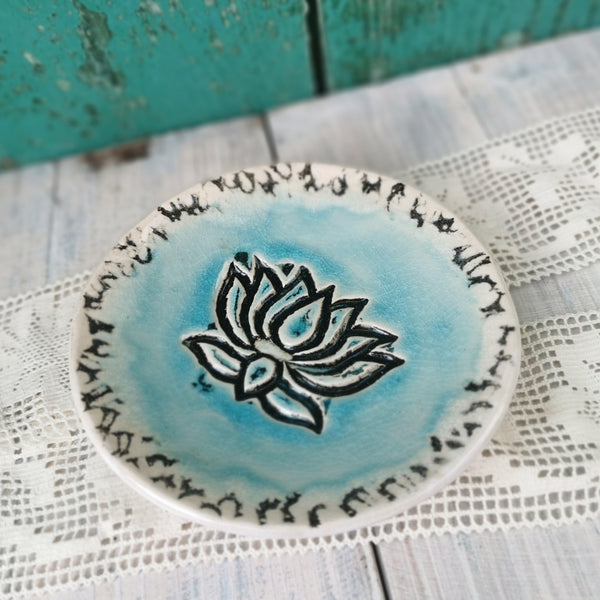 Turquoise ceramic bowl with lotus flower pattern